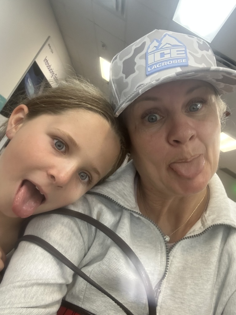 Mom and daughter wearing a camo ICE Lacrosse patch hat
