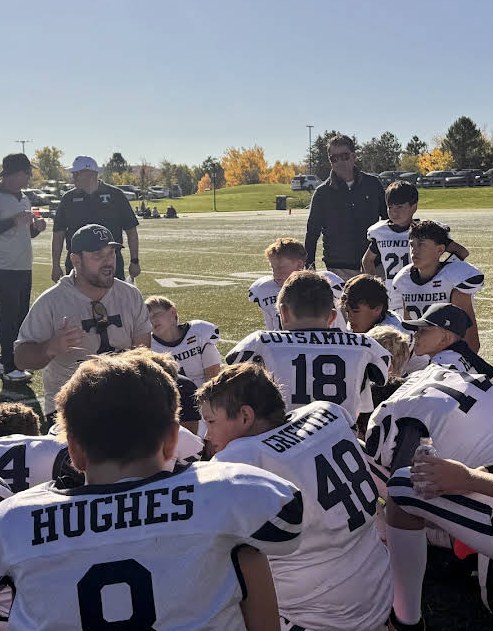 Littleton Thunder football team gathered on the field