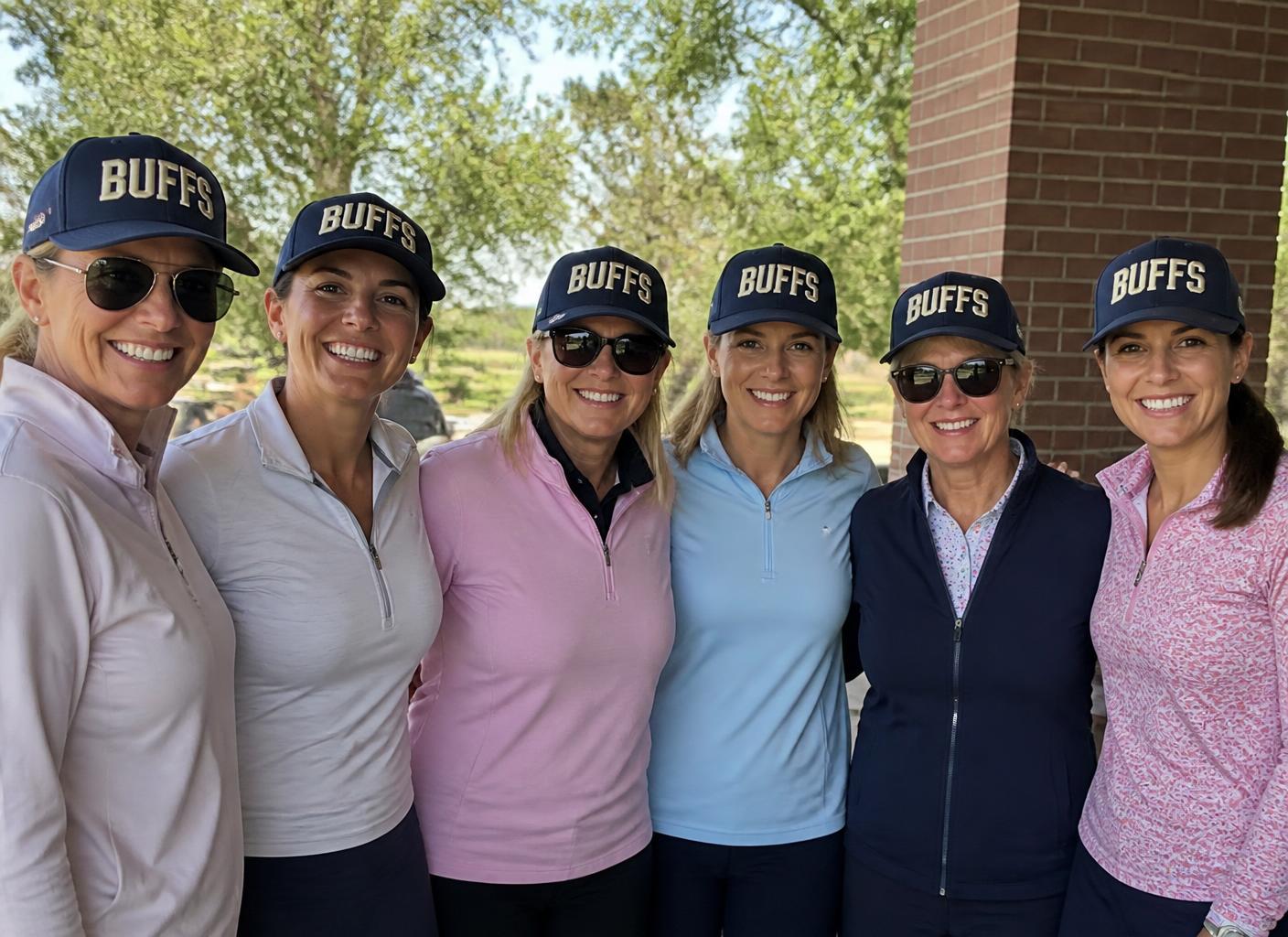 Six friends wearing matching BUFFS custom patch hats together outdoors