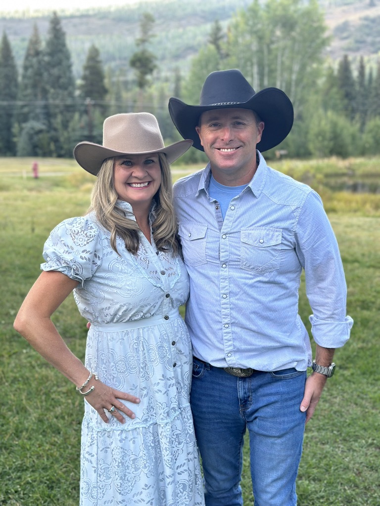 The owners of Platte River Hat Co. in a Colorado mountain meadow wearing felt hats