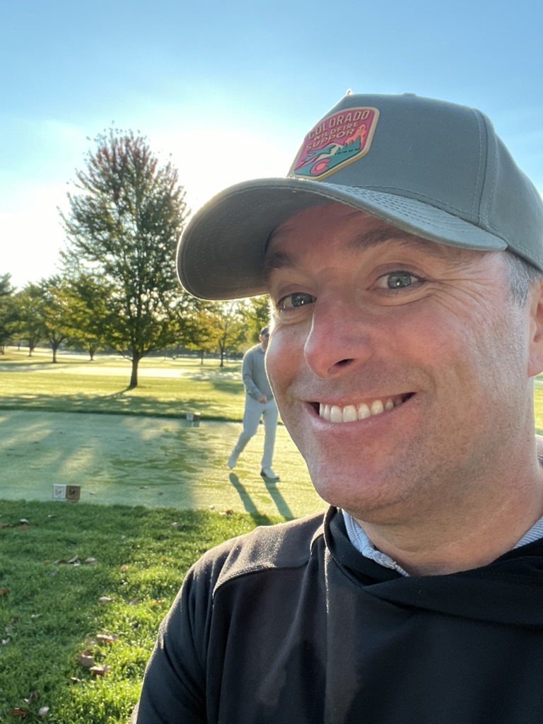 Close-up of a Colorado Wildfire Support patch hat on the golf course