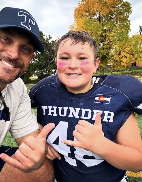 Littleton Thunder coach and player wearing custom team hats and apparel