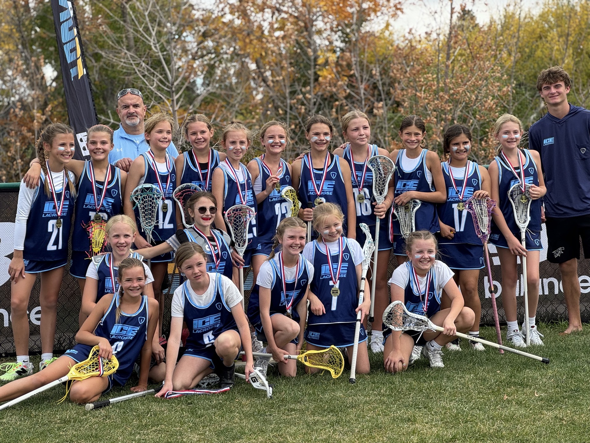 ICE 2035s girls lacrosse team with medals after a tournament win