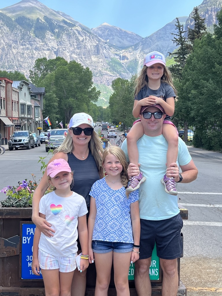 Family in downtown Telluride, Colorado wearing custom hats