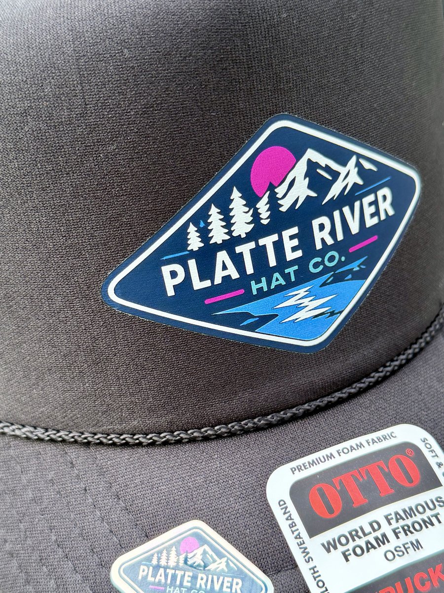 Charcoal Otto foam trucker with a full-color DTF Platte River Hat Co. emblem