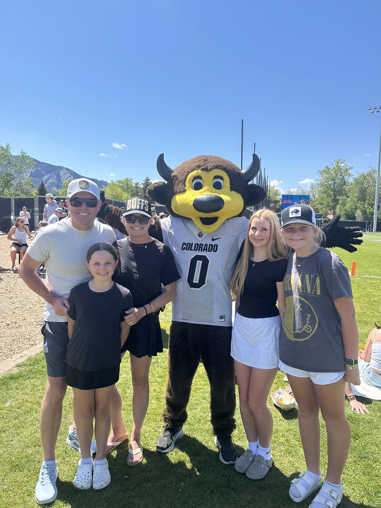 Family with the Colorado Buffaloes mascot at a spring game, wearing custom trucker hats